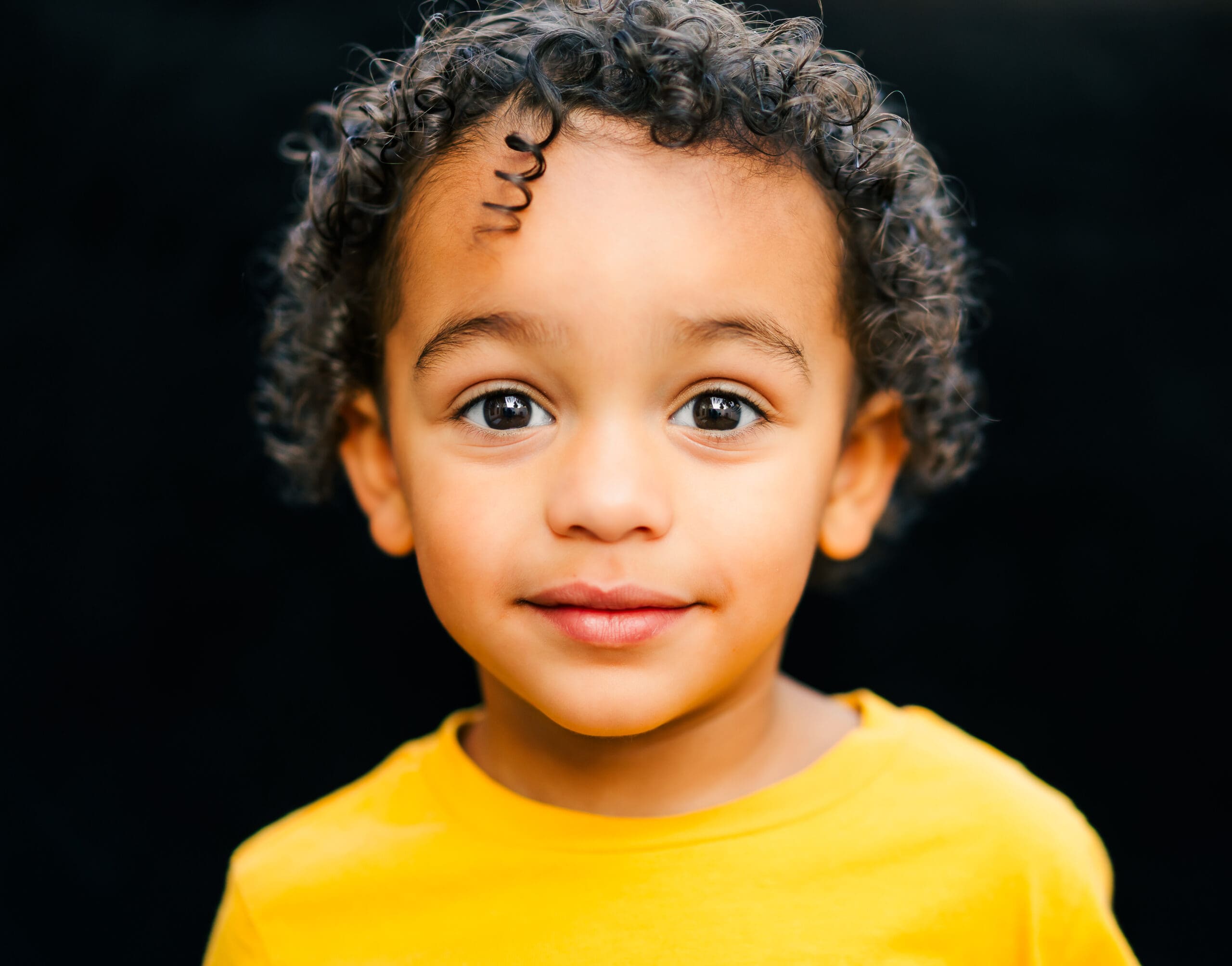 School portrait of child with natural expression on a black backdrop in Middle Tennessee by S. Reed Photography