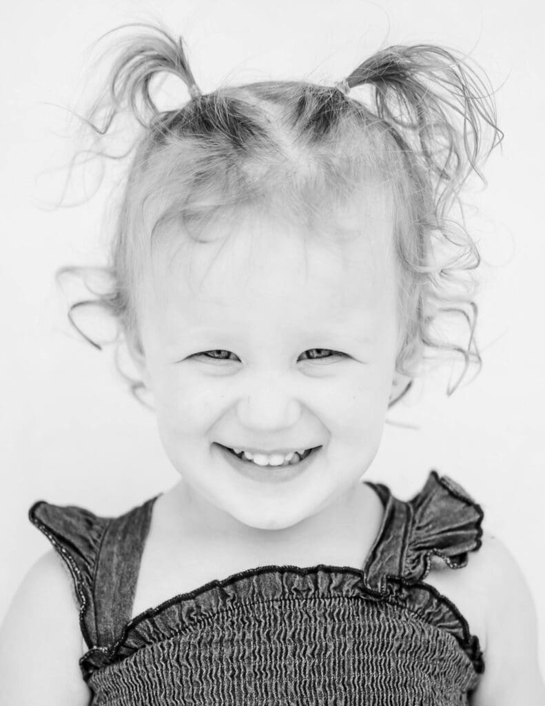 Black and white fine art child portrait with natural expression on a neutral backdrop in Middle Tennessee by S. Reed Photography