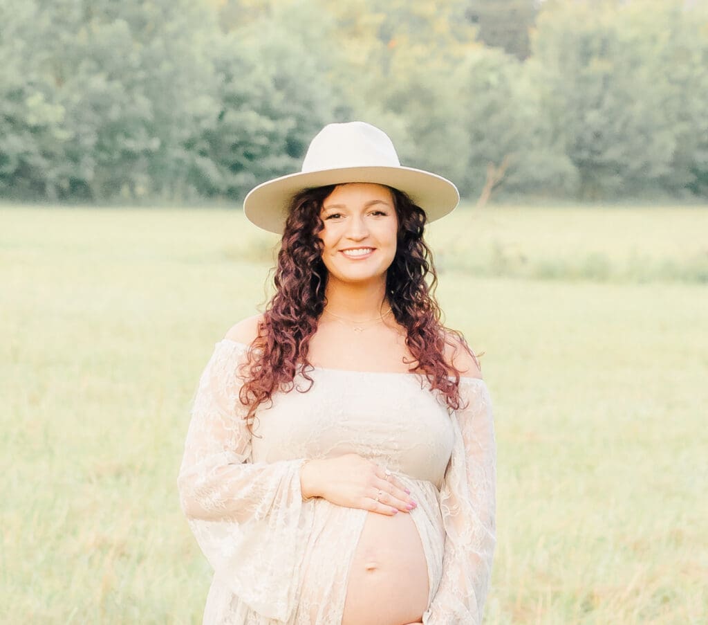Outdoor maternity portrait of an expecting mother wearing a hat in Murfreesboro Tennessee