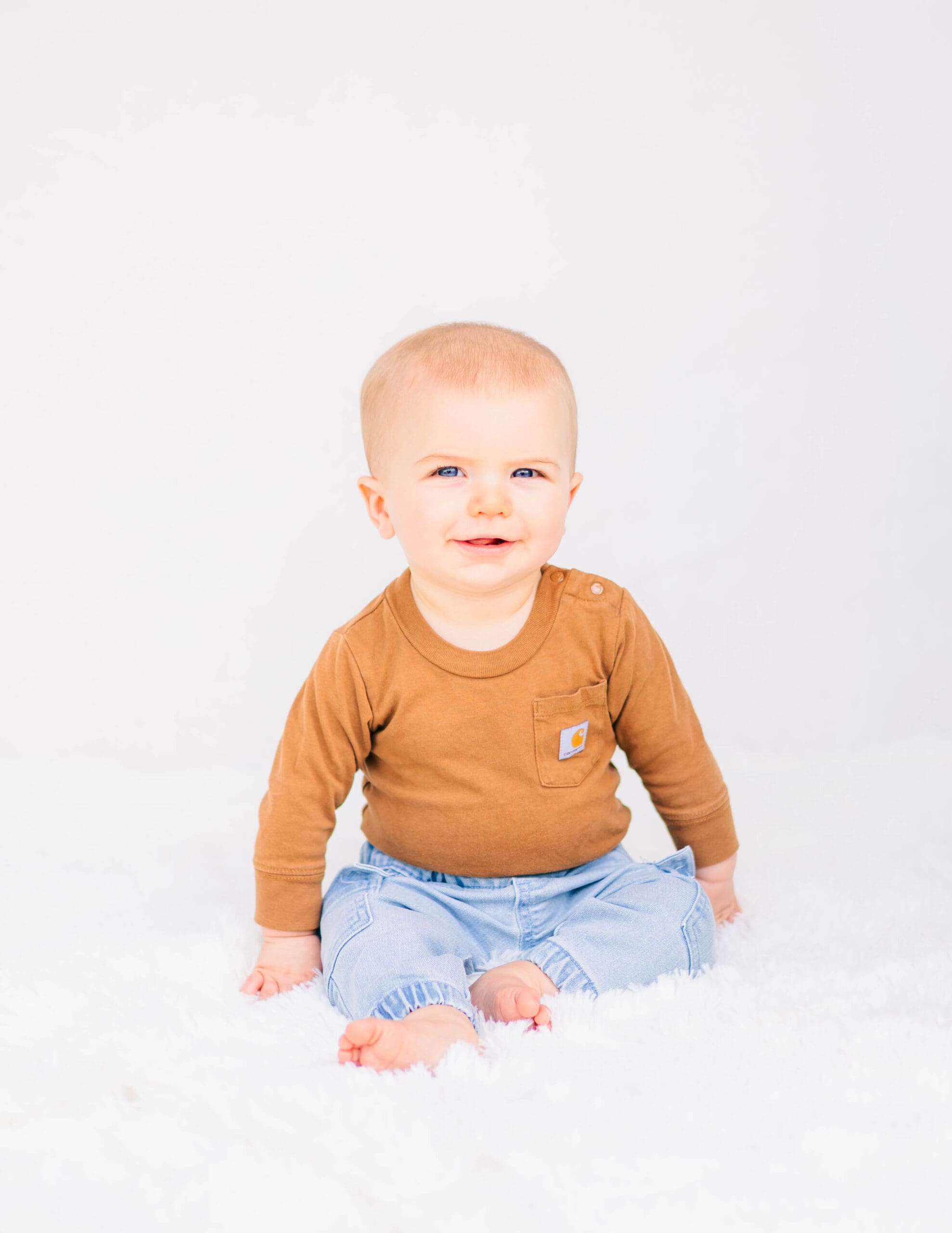 Toddler boy wearing a simple solid color outfit for school picture day portrait on a clean neutral background by Murfreesboro school photographer S. Reed Photography.
